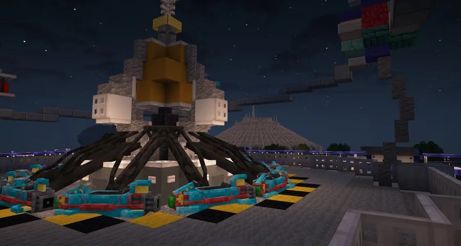 Astro Orbiter rockets at night with Space Mountain in the background